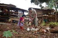 Thai village child with her father